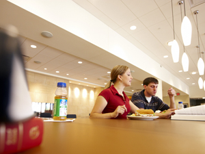 Two students eating at a table