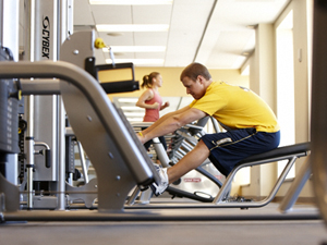 a student using a weight machine